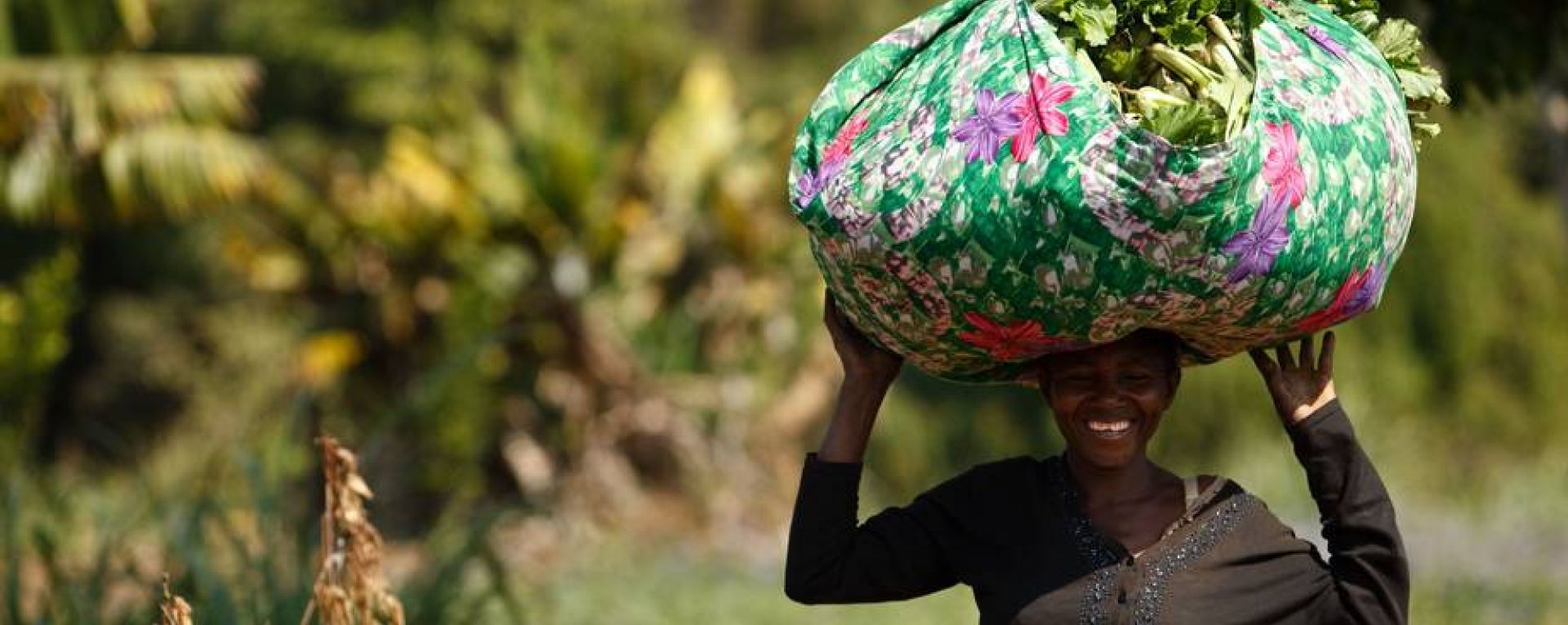 Woman carrying sack of crops