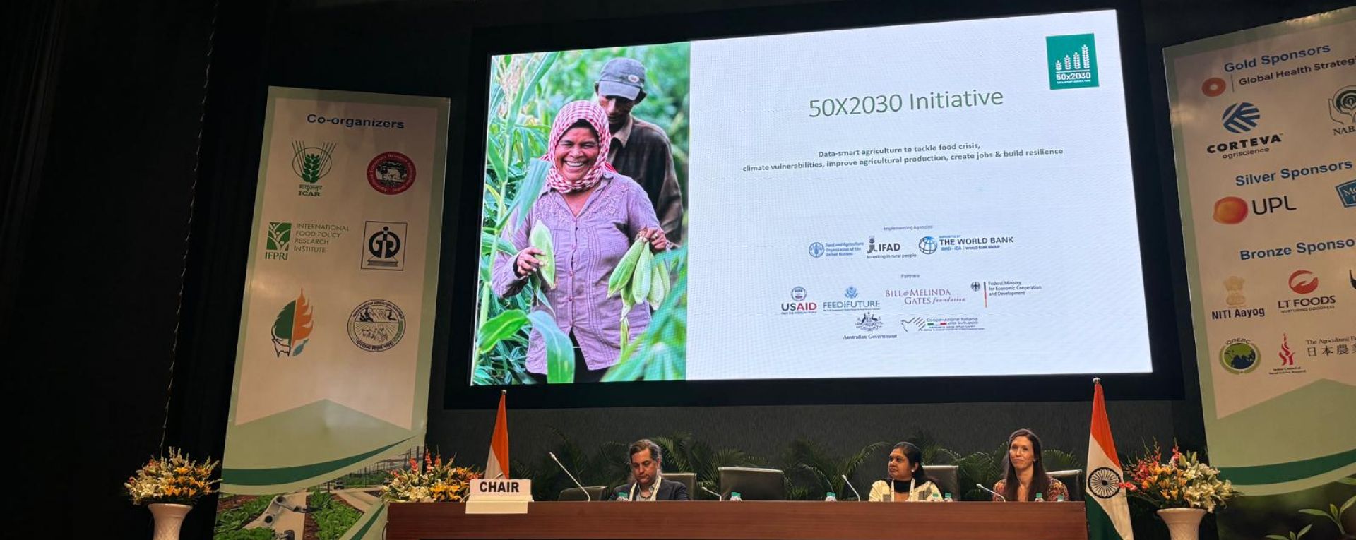 50x2030 presenters next to a slide show