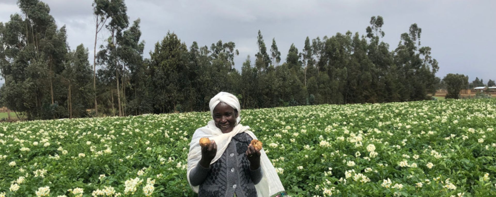 Woman holding crops in a field