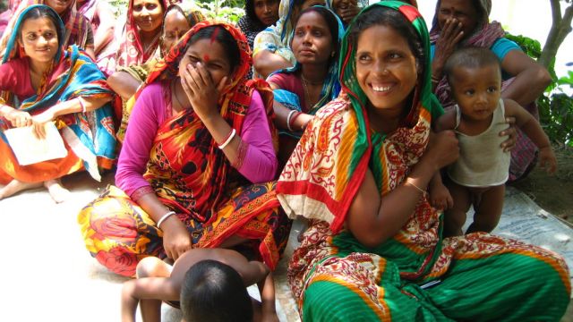 Women smiling with children